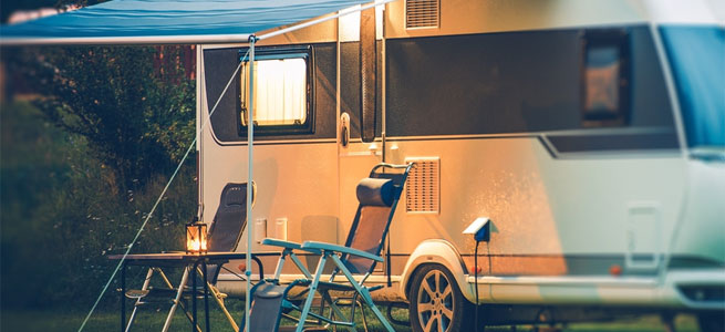 Caravan at caravan park with camping chairs