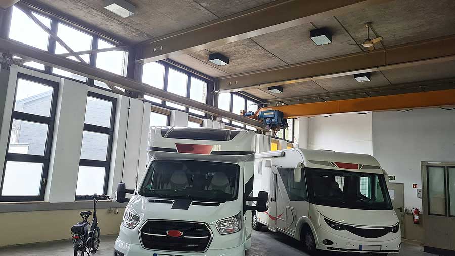 two motorhomes in indoor winter storage shed