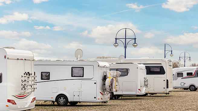 motorhomes in a line at a caravan site